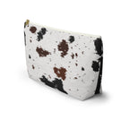Side view of the black brown cow print makeup bag standing upright