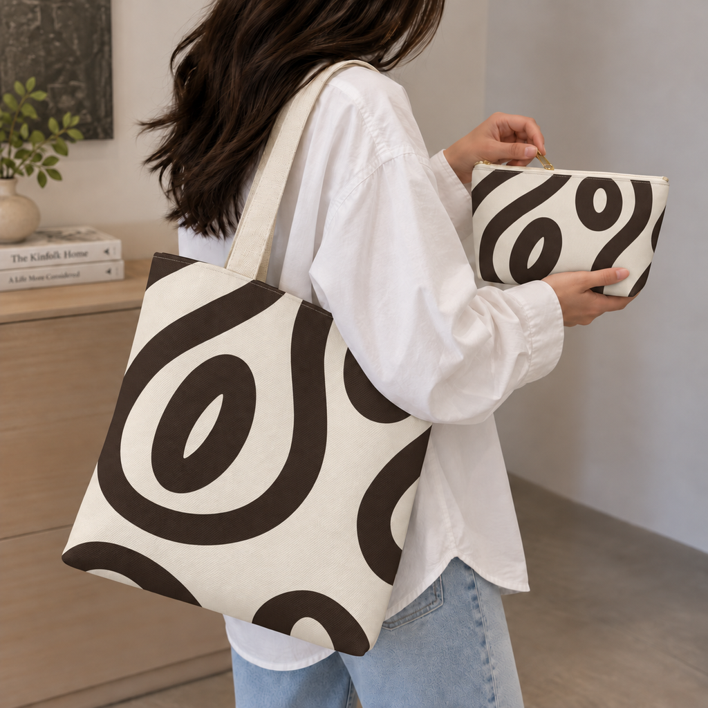 Woman carrying the black cream abstract tote bag with the matching makeup bag in her hand