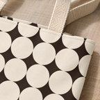 Close-up of the cream circles on black and the handle of the geometric tote bag