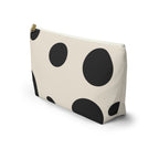 Side view of the black cream polka dot makeup bag standing upright