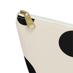 Close-up of the gold zipper pull on the black polka dot makeup bag