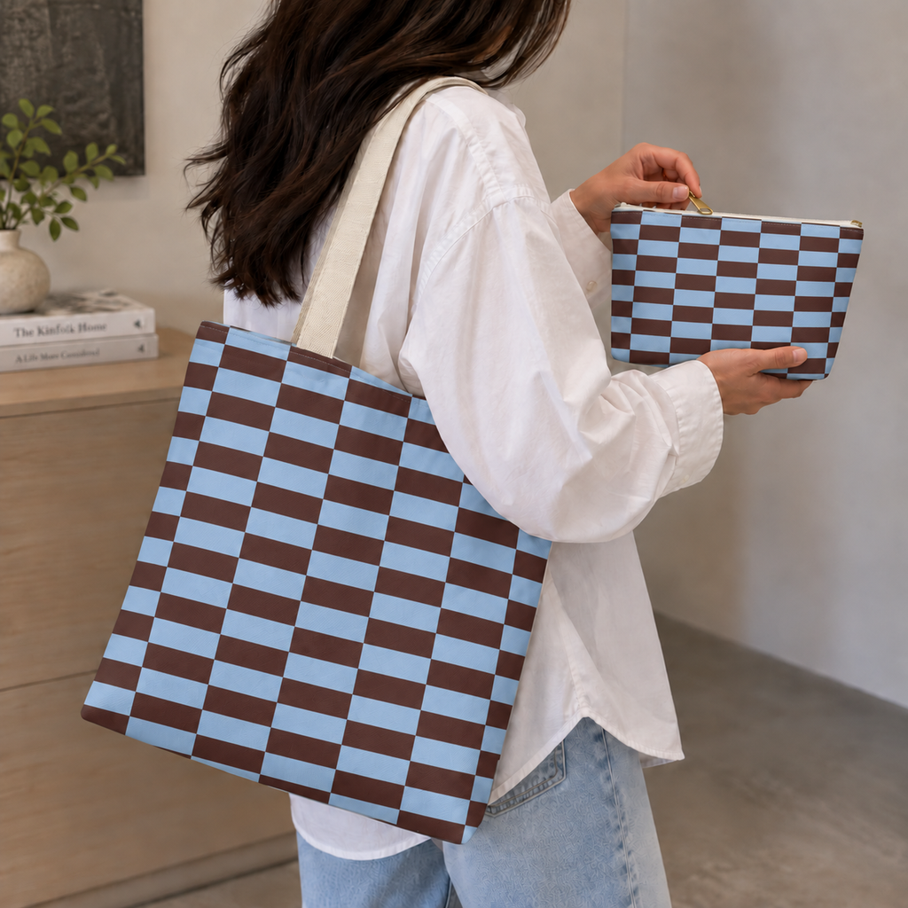 Woman carrying the blue brown brick tote bag and holding the matching makeup bag