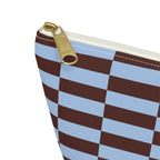Close-up of the gold zipper pull and blue brown block print on the makeup bag
