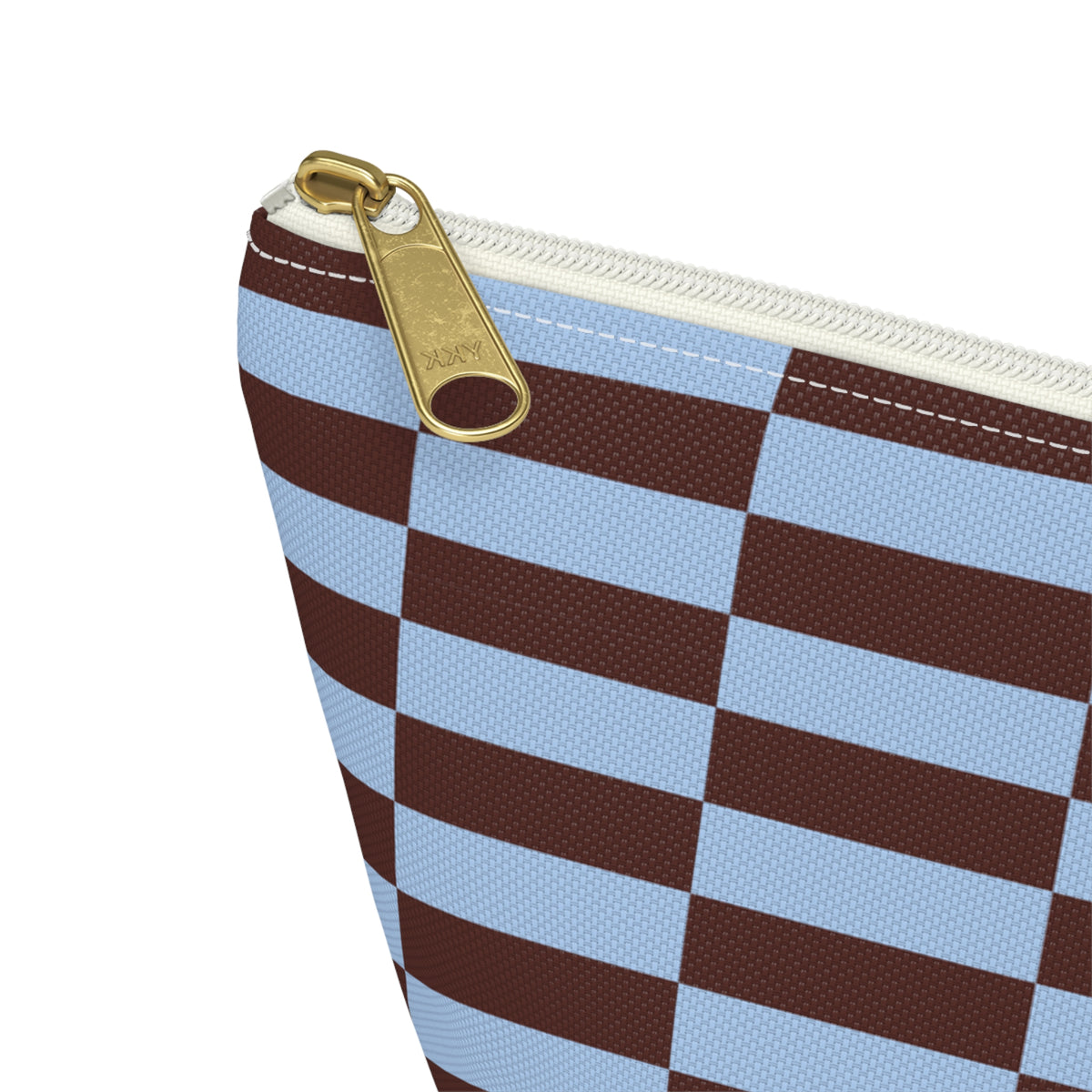 Close-up of the gold zipper pull and blue brown block print on the makeup bag