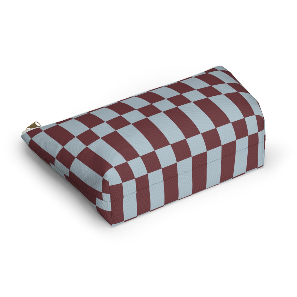 Blue burgundy checkerboard makeup bag lying on its side showing the checkered pattern