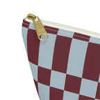 Close-up of the gold zipper pull and burgundy and blue checks on the makeup bag