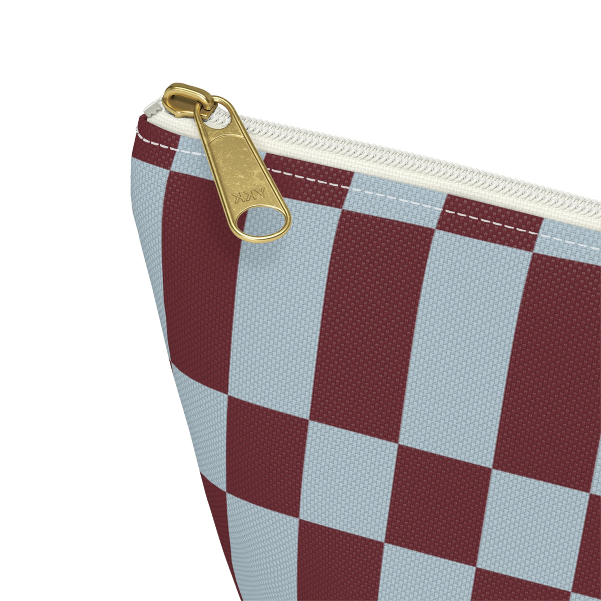 Close-up of the gold zipper pull and burgundy and blue checks on the makeup bag