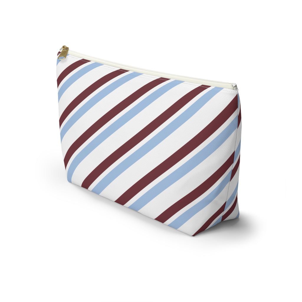 Side view of the blue burgundy diagonal striped makeup bag standing on a white background