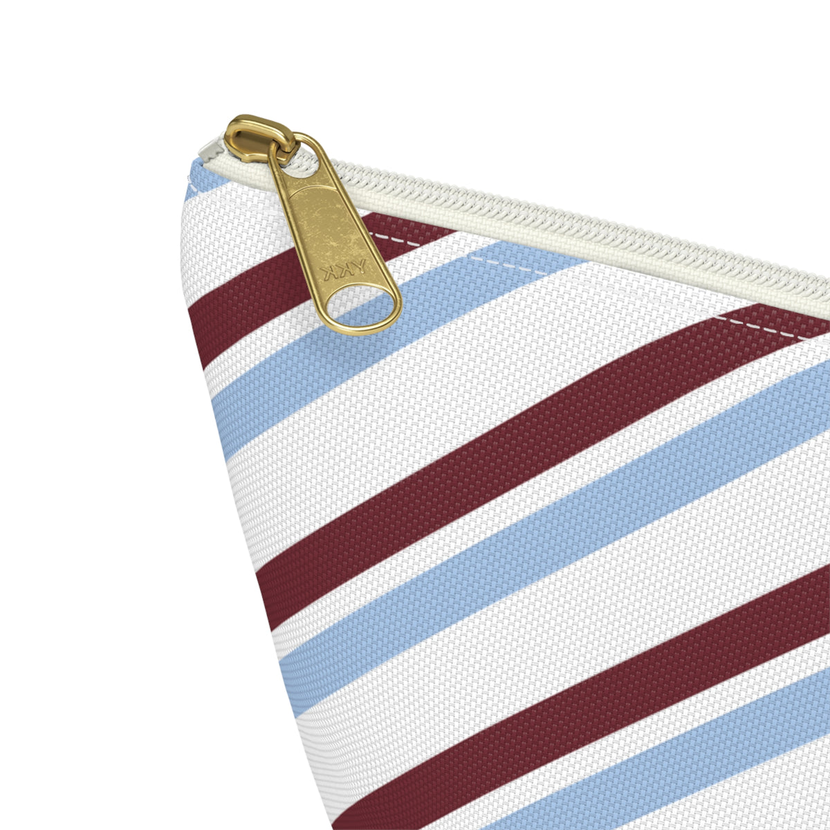 Close-up of the gold zipper pull and blue burgundy stripes on the makeup bag