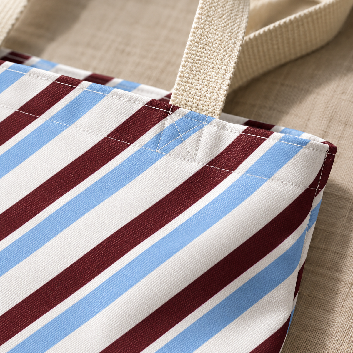Close-up of the blue and burgundy diagonal stripe print on the tote bag