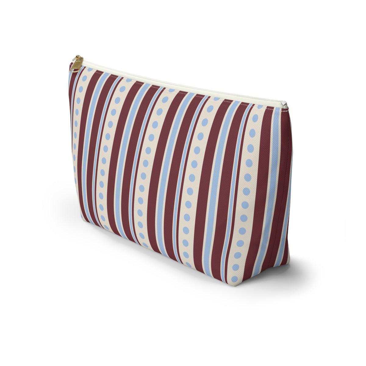 Side view of the blue burgundy dot striped makeup bag standing on a white background