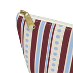 Close-up of the gold zipper pull and blue dotted stripes on the makeup bag