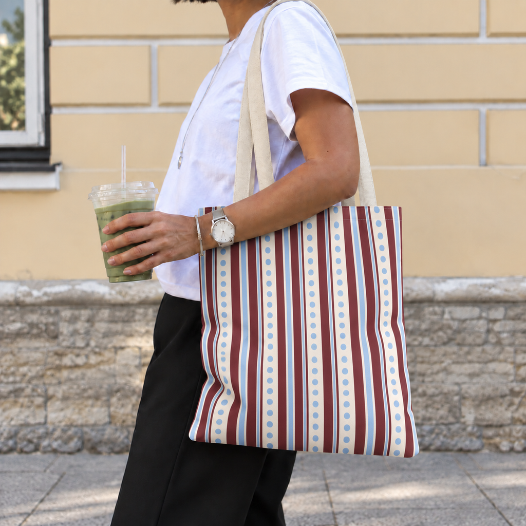 Woman carrying the blue burgundy dot striped tote bag on her shoulder on the street