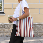 Woman carrying the blue burgundy dot striped tote bag on her shoulder on the street
