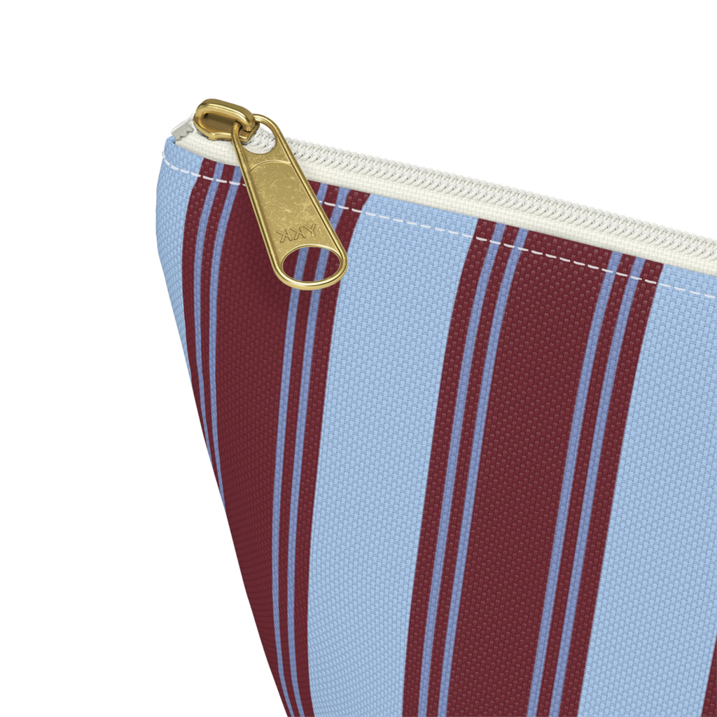 Close-up of the gold zipper pull on the striped makeup bag