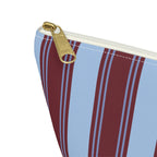 Close-up of the gold zipper pull on the striped makeup bag