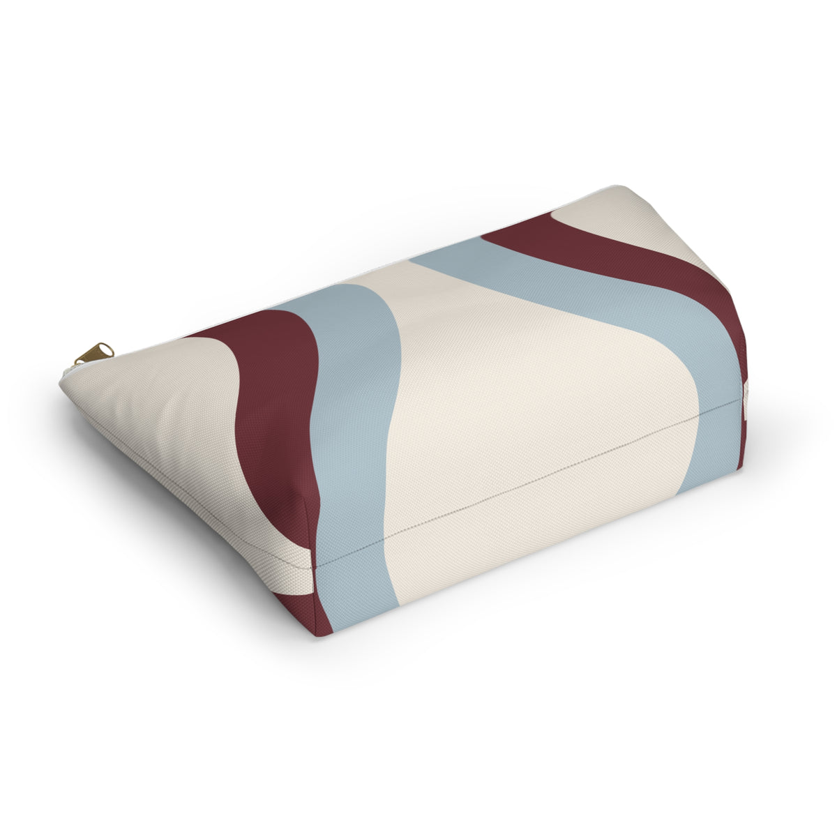 Wavy makeup bag lying on its side showing the blue and burgundy curved print
