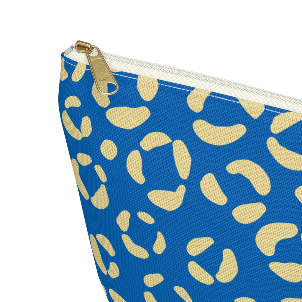 Close-up of the gold zipper pull and cream leopard spots on the makeup bag