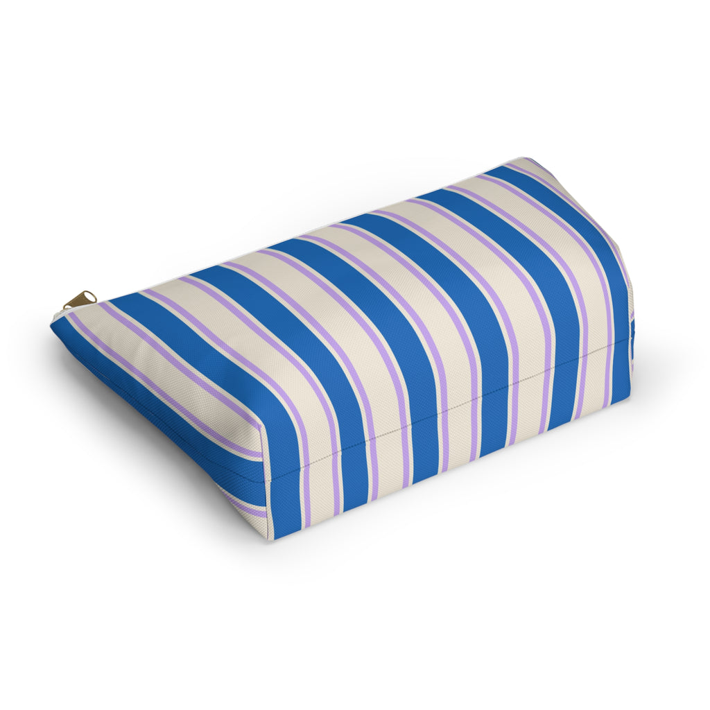 Angled view of the striped makeup bag lying on its side