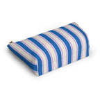 Angled view of the striped makeup bag lying on its side