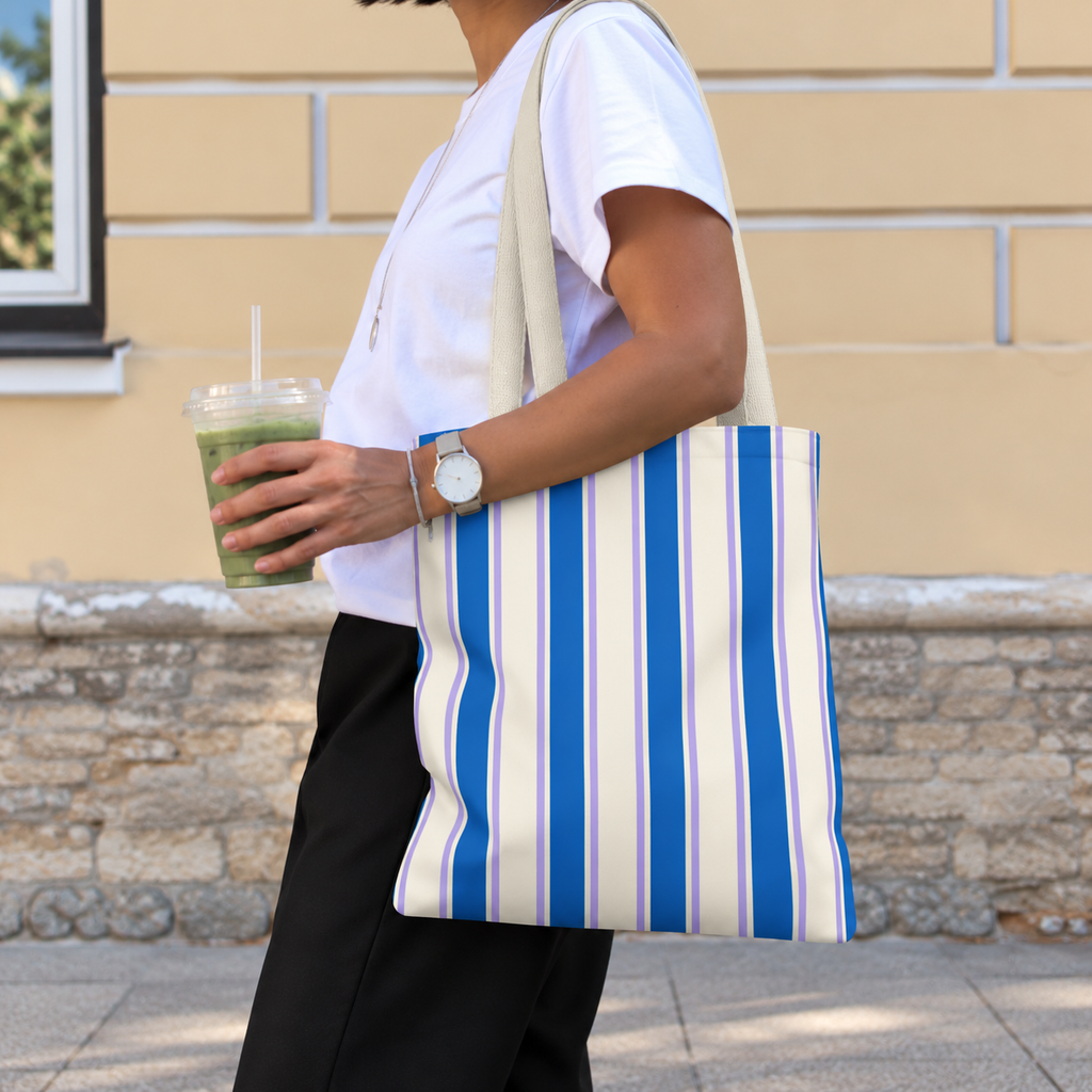 Woman walking with the Blue Cream Striped tote bag on her shoulder