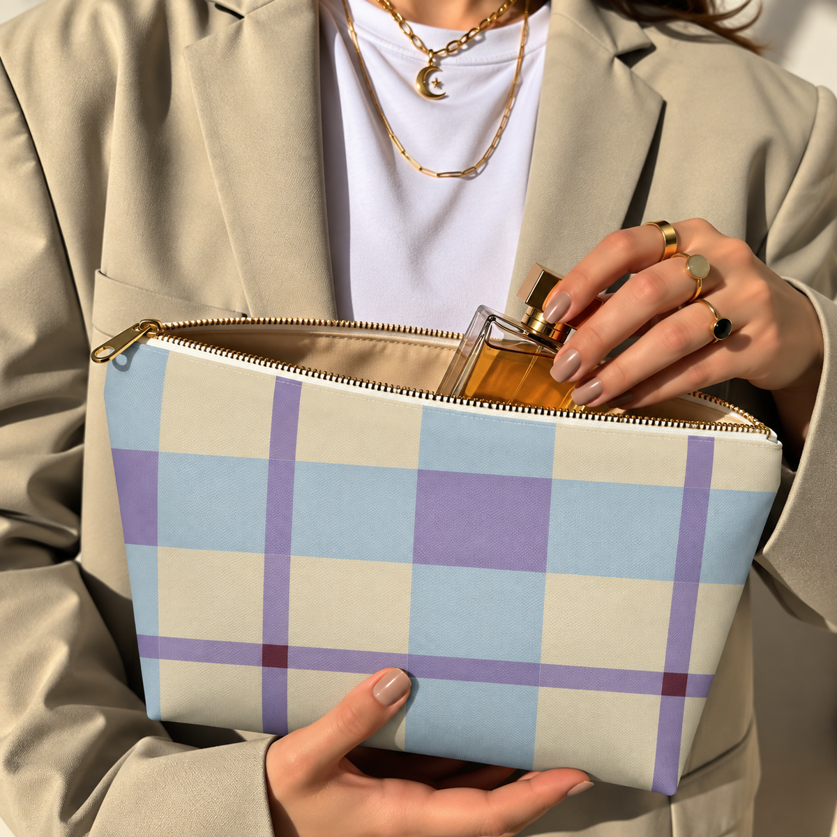 Model in a beige blazer taking a product out of the open blue lilac cream plaid makeup bag