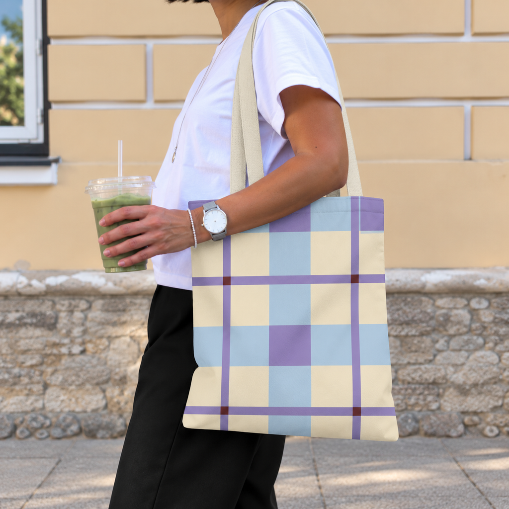 Side view of a model carrying the blue lilac cream plaid tote bag on the shoulder