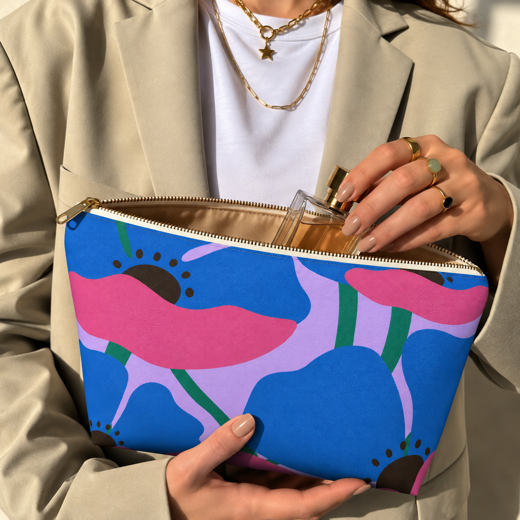 Hands holding the open poppy floral makeup bag with a perfume bottle inside