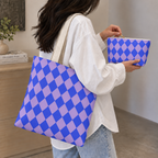 Woman with a checkered tote bag and matching blue purple makeup bag in hand