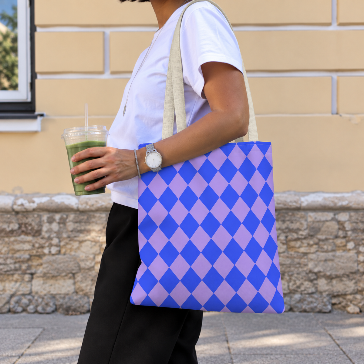 Woman walking with the blue purple diamond checkered tote bag on her shoulder