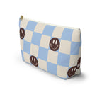 Side view of the blue smiley face checkered makeup bag standing upright