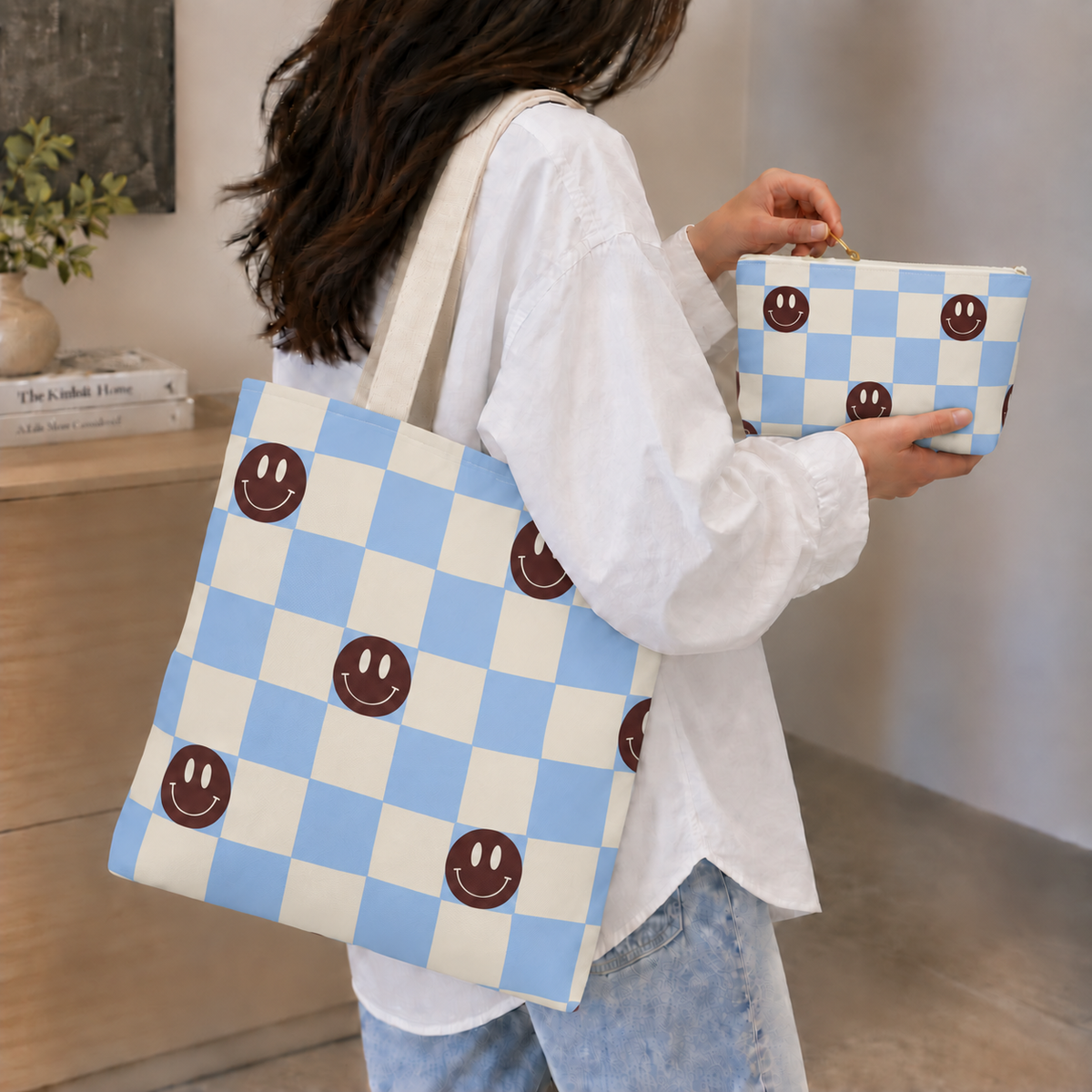 Model carrying the checkered tote bag on her shoulder with the matching blue makeup bag in hand