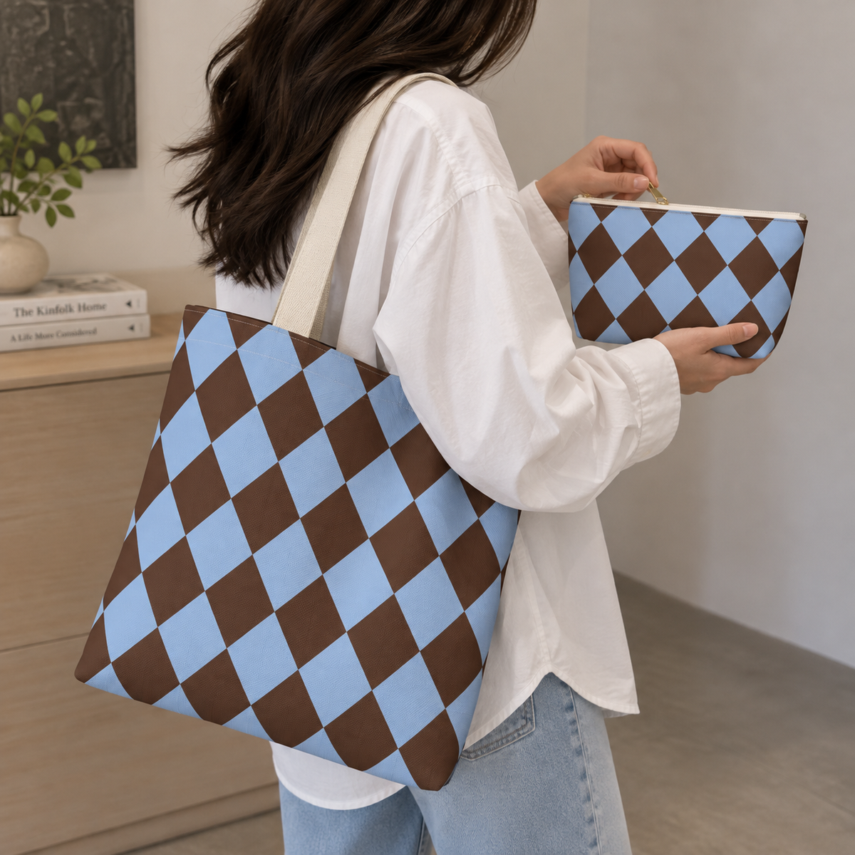 Woman carrying a brown blue diamond checkered tote bag and matching makeup bag