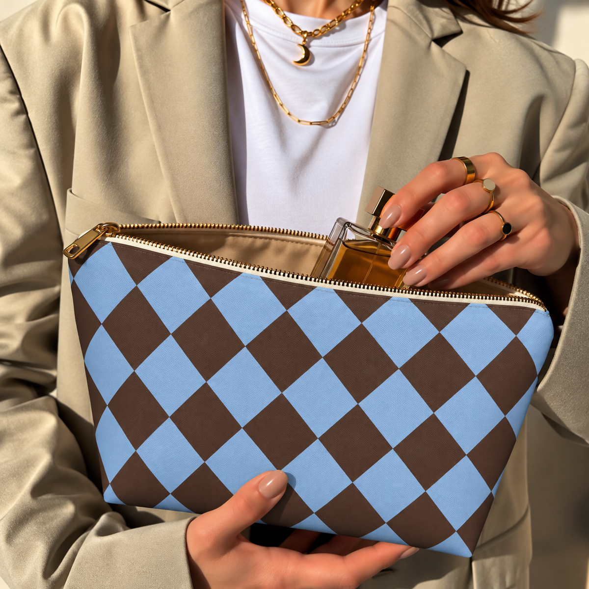 Hands opening a brown blue diamond checkered makeup bag filled with cosmetics