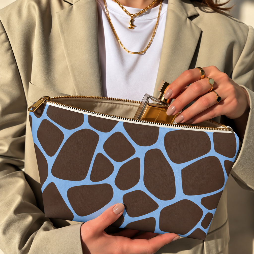 Hands opening a brown blue giraffe print makeup bag filled with cosmetics