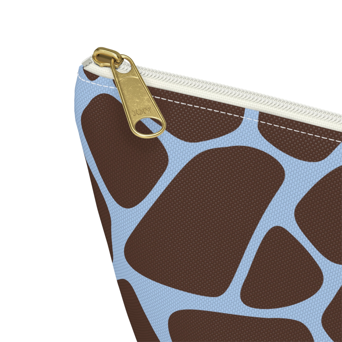 Close-up of the gold zipper pull and sky blue lines on the makeup bag