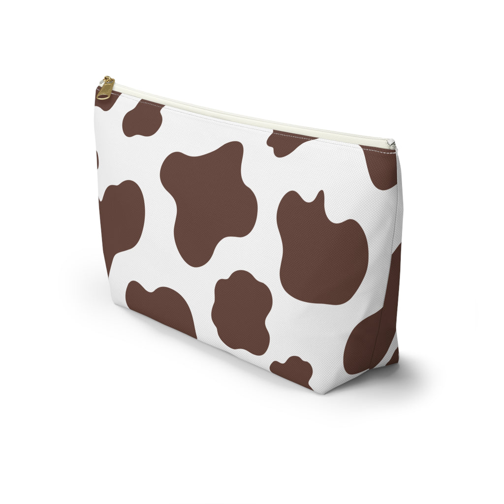 Side view of the brown cow print makeup bag standing upright