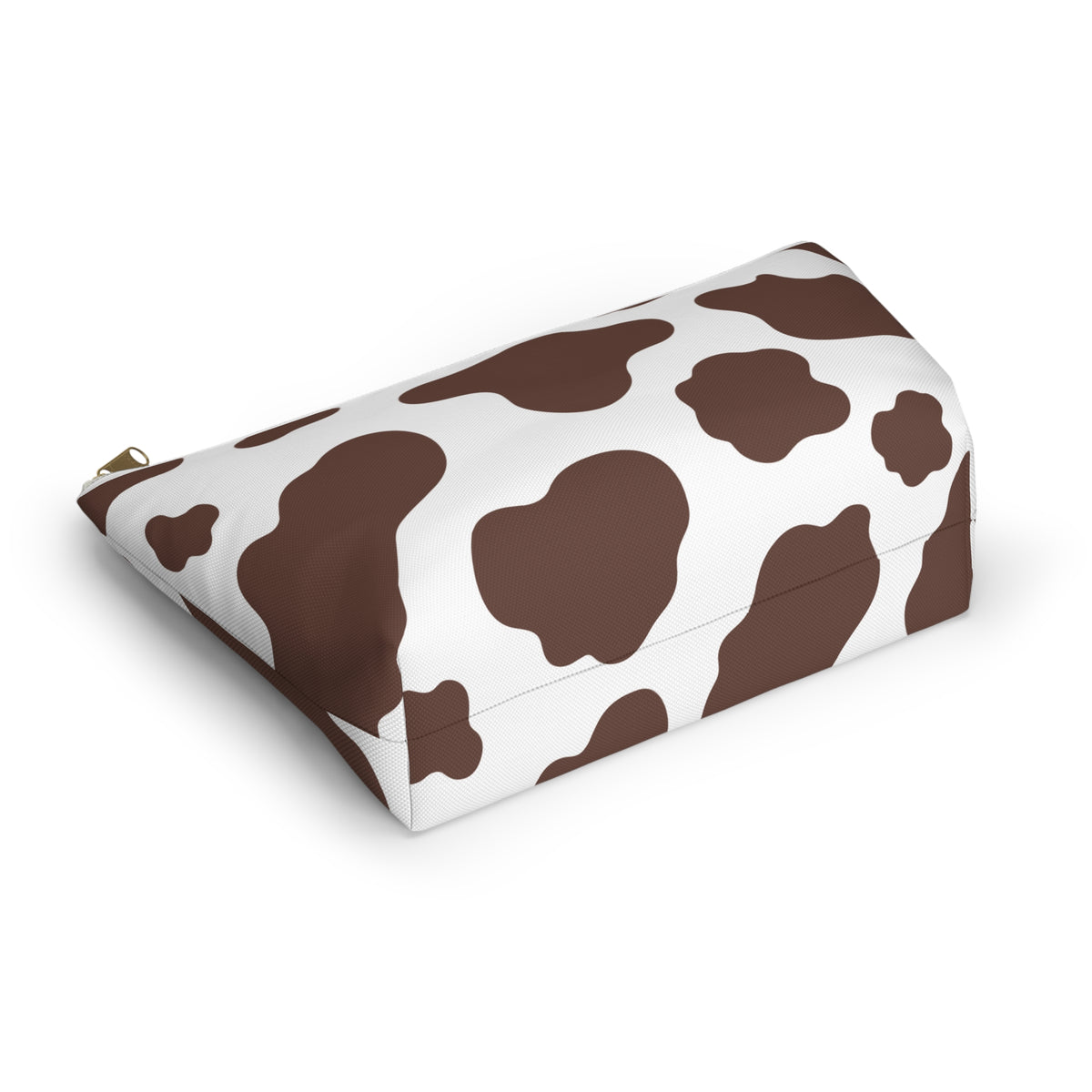 Brown and white cow print cosmetic bag lying at an angle