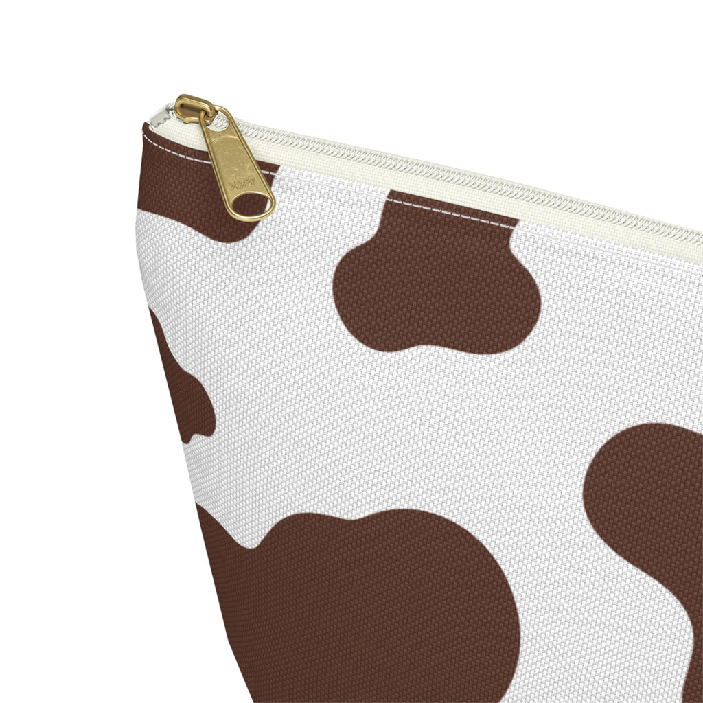 Close-up of the gold zipper pull on the brown cow print makeup bag