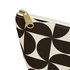 Close-up of the gold zipper pull and brown geometric print on the makeup bag