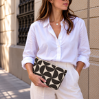 Woman in white shirt holding the brown cream geometric makeup bag
