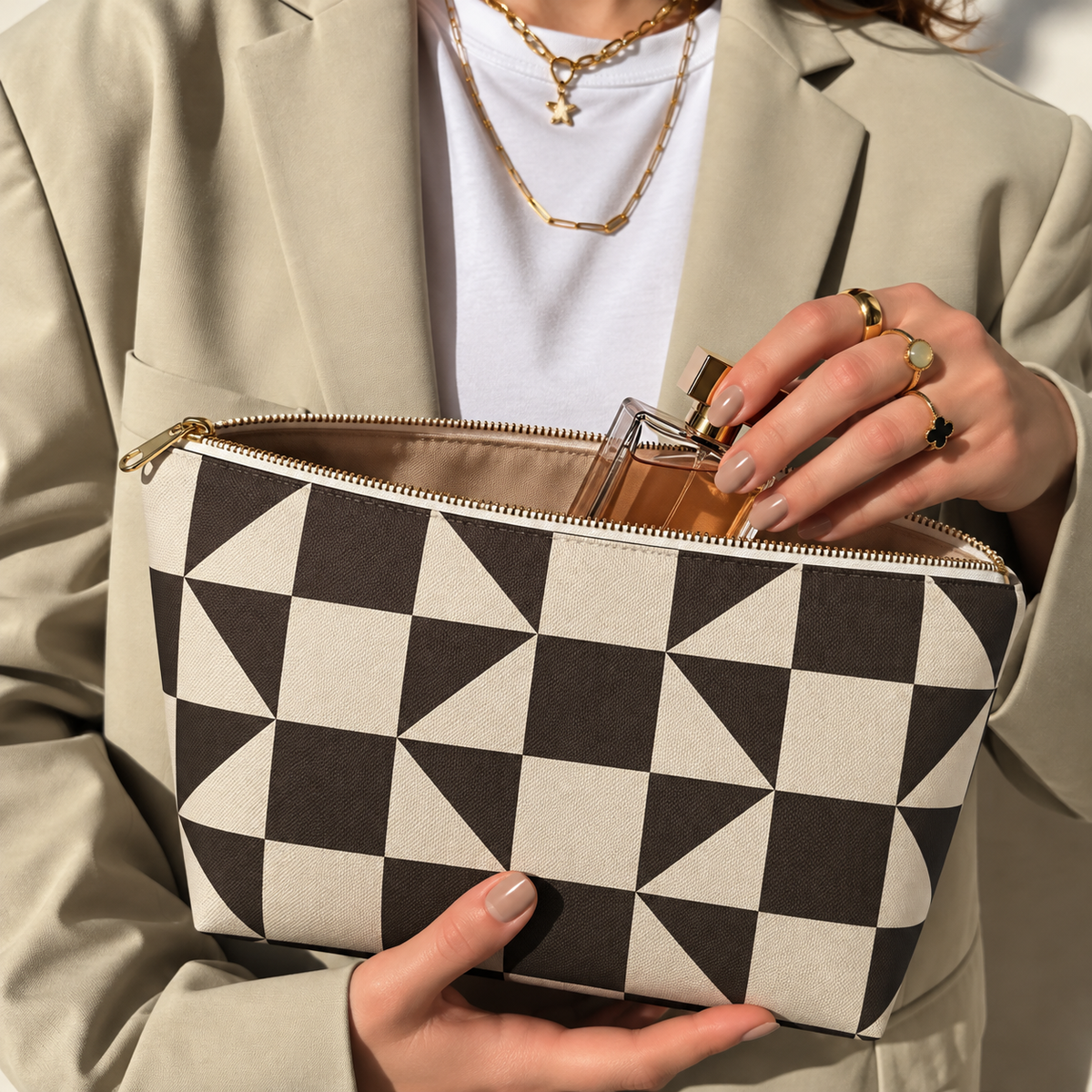 Hands holding the open brown cream triangle makeup bag