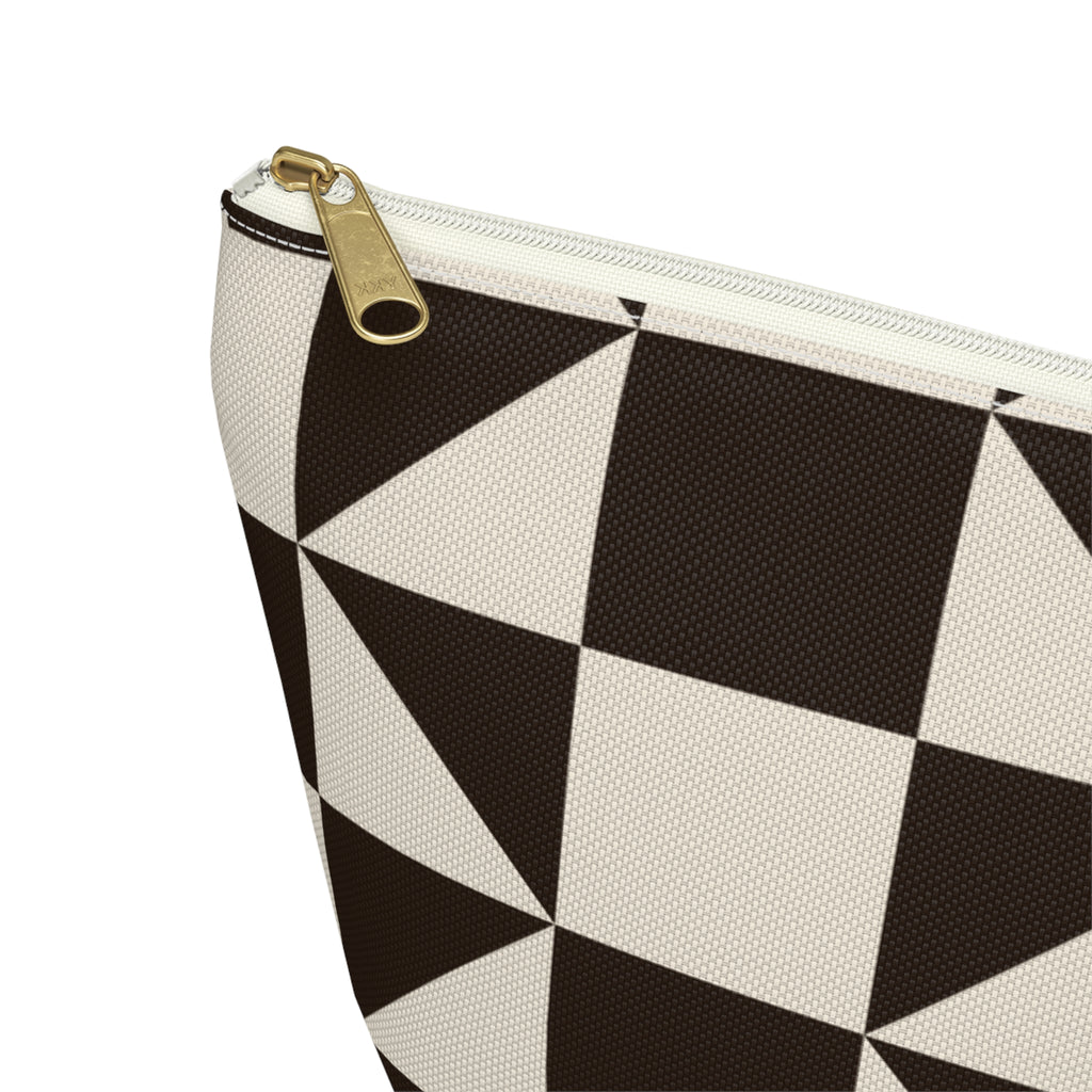 Close-up of the gold zipper pull and brown triangle print on the makeup bag
