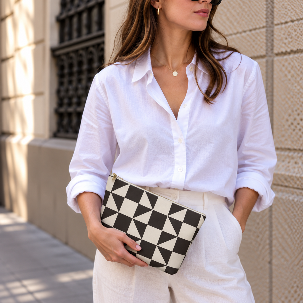 Woman in white shirt holding the brown cream triangle makeup bag