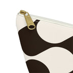 Close-up of the gold zipper pull and brown wave print on the makeup bag