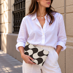 Woman in white shirt holding the brown cream wave makeup bag