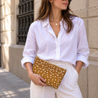 Woman in a white shirt holding the Brown Fawn Spotted makeup bag