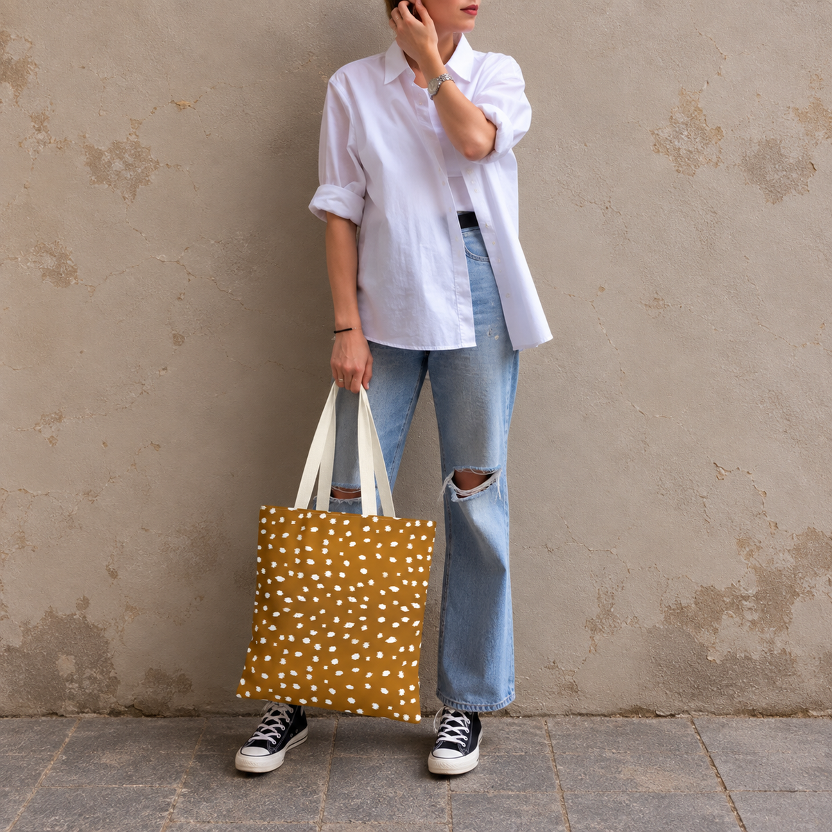 Model standing outdoors with the Brown Fawn Spotted tote bag in a full-body photo