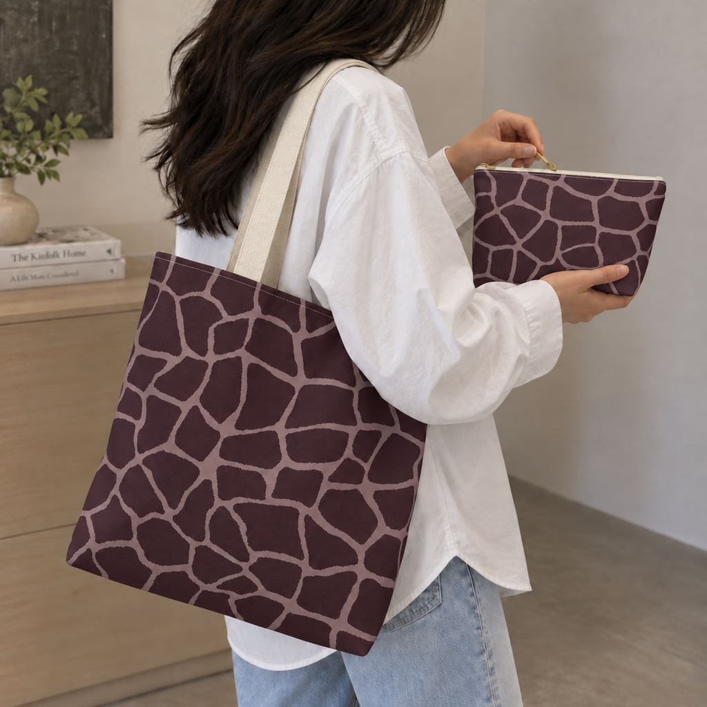 Woman carrying a brown pink giraffe print tote bag and matching makeup bag