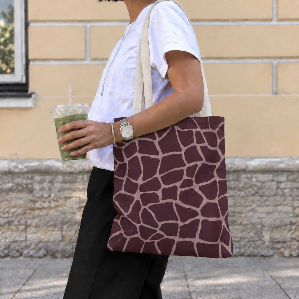 Woman with a brown giraffe print tote bag with pink lines over her shoulder